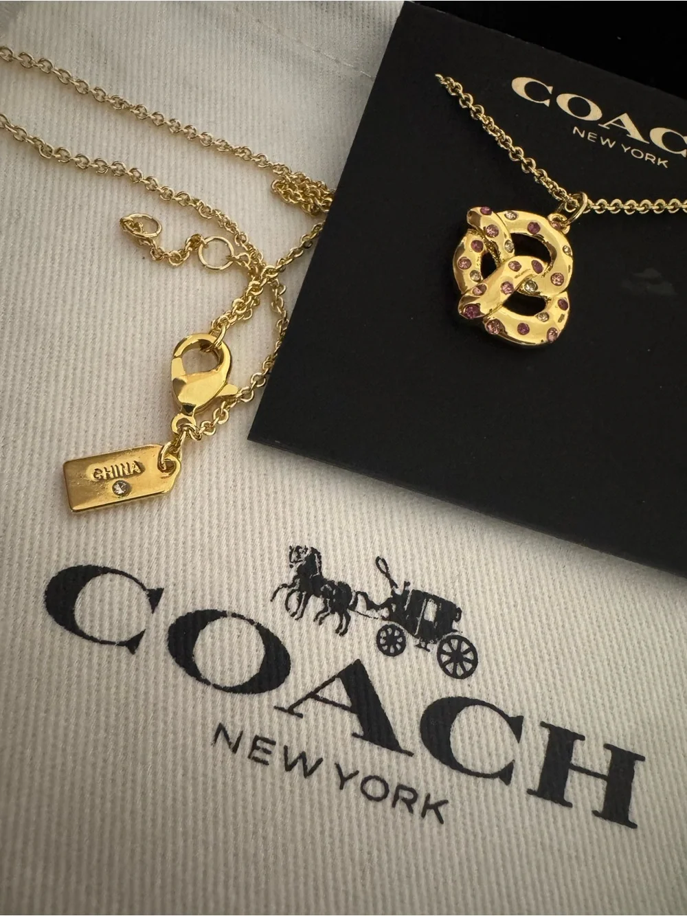 Coach Gold Pretzel Pendant Necklace with Pink Accents